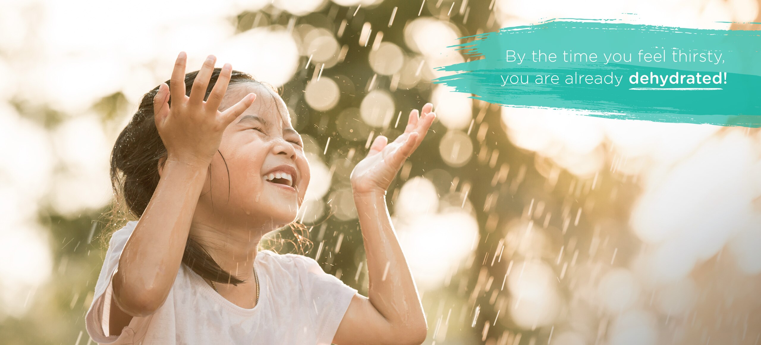 A child feeling rejuvented and happy to have rain water falling on their face